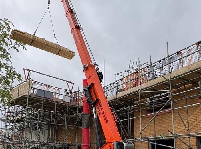 Crane on construction site with load