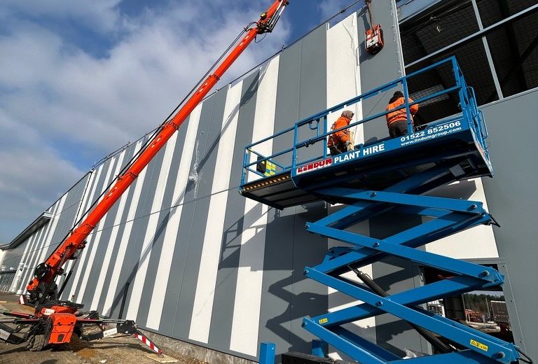 Scissor lift next to warehouse